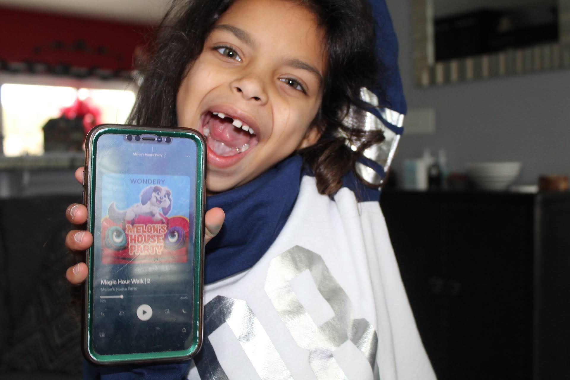 Little girl listening on Podcast, Laughing and Dancing holding phone